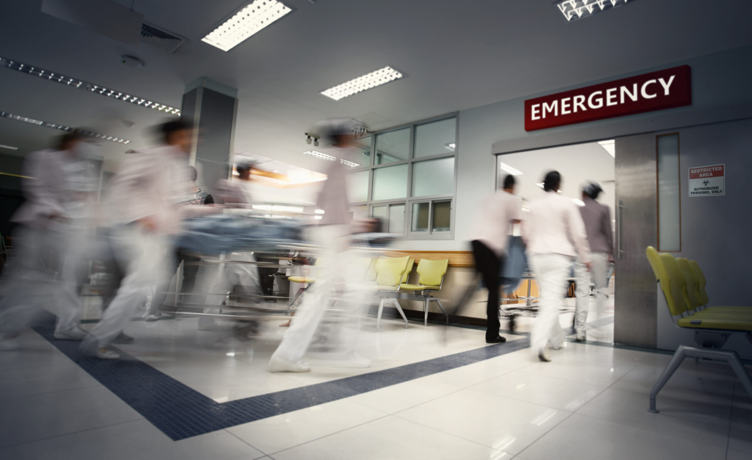 A motion blurred photograph of a patient on stretcher or gurney being pushed at speed through a hospital corridor.New corona virus (novel Coronavirus 2019 disease,COVID-19,nCoV).